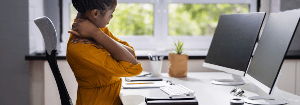 ergonomic chair with person sitting down while holding their neck